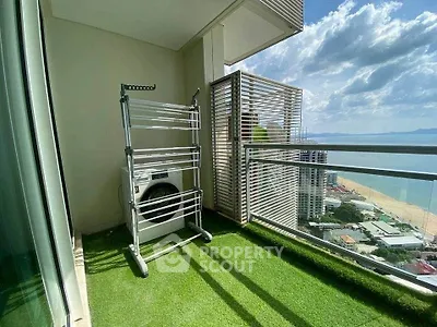 Stunning high-rise balcony with ocean view and laundry area, perfect for urban living.