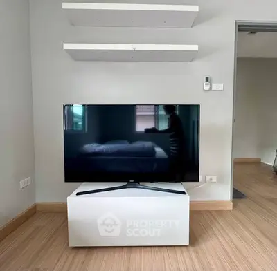 Modern living room with sleek TV stand and floating shelves