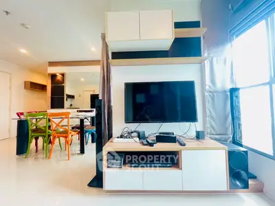 Modern living room with sleek entertainment center and colorful dining chairs