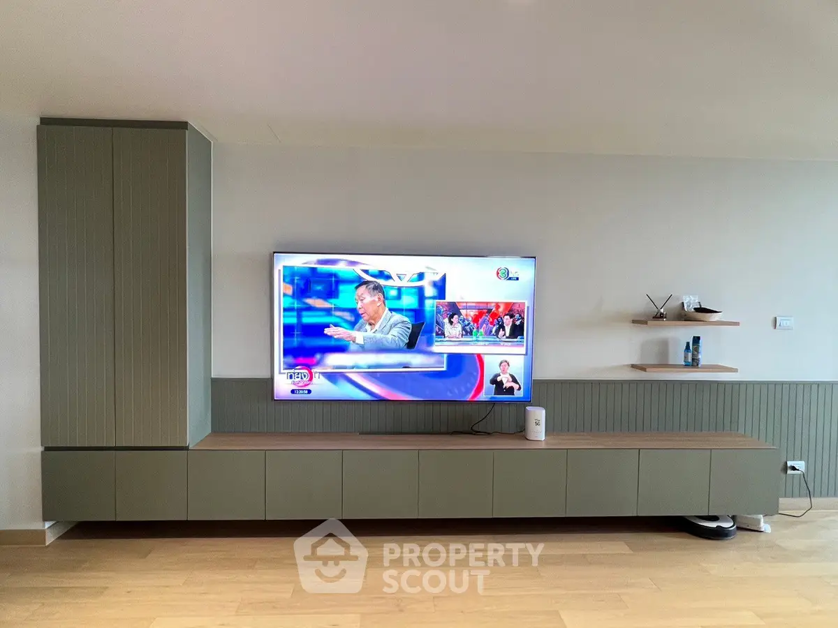 Modern living room with sleek TV unit and wall-mounted shelves