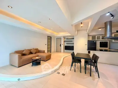 Spacious modern living room with open kitchen and stylish furniture