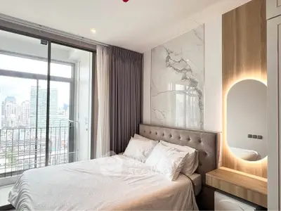 Modern bedroom with city view and elegant decor in high-rise apartment