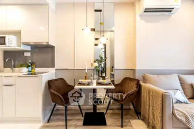 Modern dining area in cozy apartment with stylish decor and open kitchen layout.