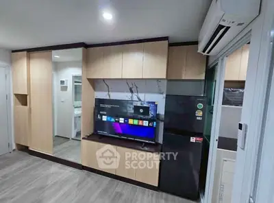 Modern living room with built-in cabinets and sleek appliances