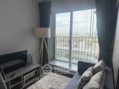 Modern living room with city view from balcony, featuring cozy sofa and stylish decor.