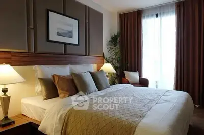 Luxurious bedroom with elegant decor and cozy lighting in modern apartment.