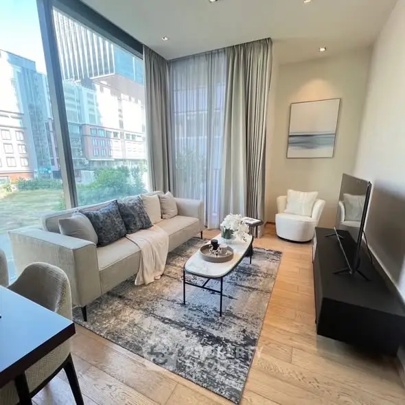 Modern living room with large windows and stylish decor in urban apartment.