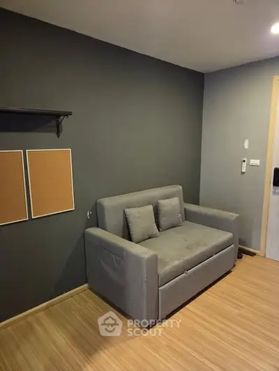 Cozy living room with modern gray sofa and wooden flooring