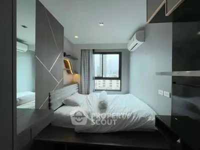 Modern bedroom with city view, featuring sleek design and ample natural light.