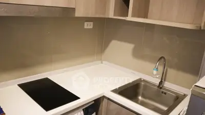 Modern kitchen with sleek countertop and built-in electric stove