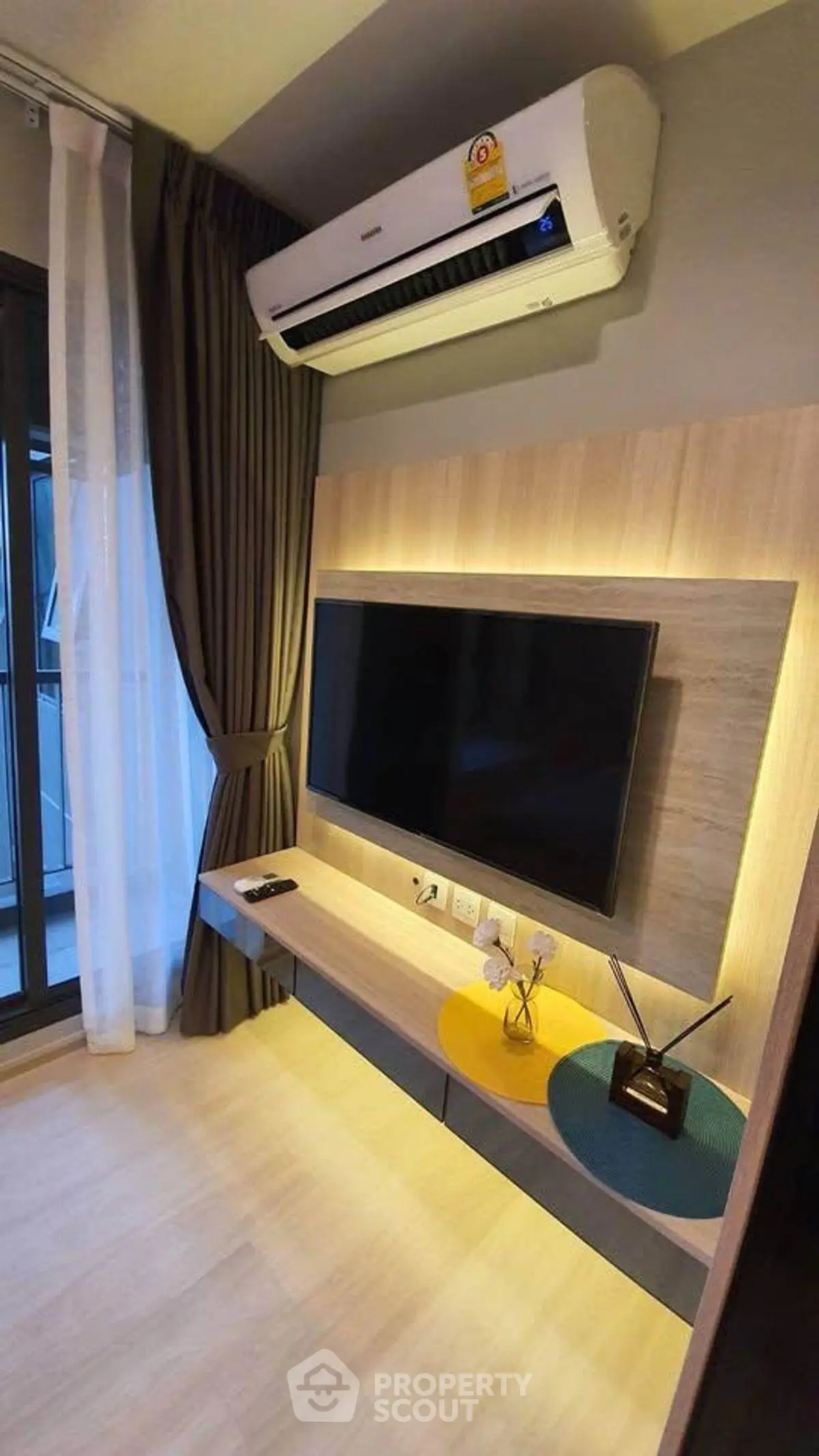 Modern living room with wall-mounted TV and air conditioning unit