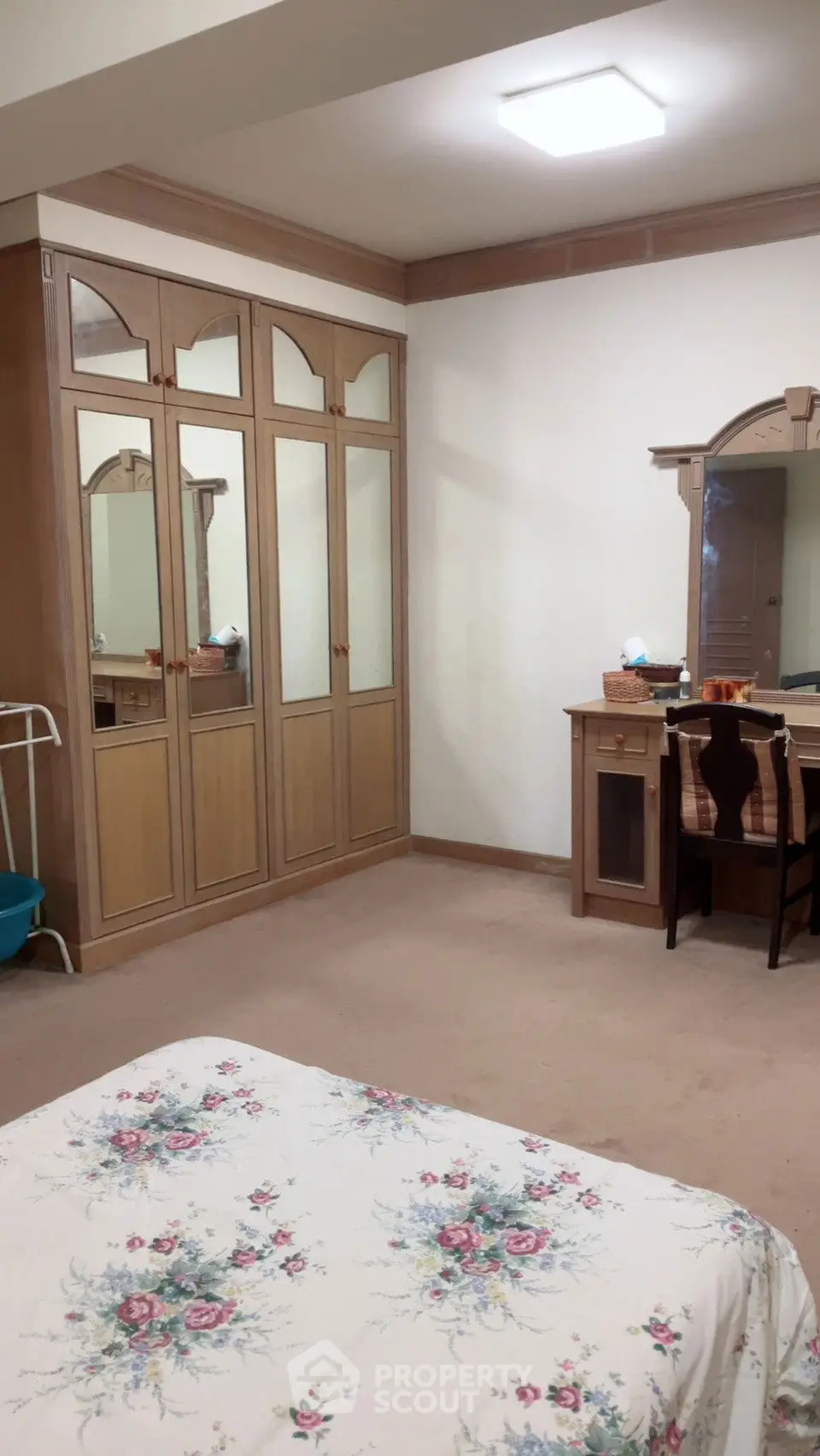 Spacious bedroom with mirrored wardrobe and elegant vanity desk