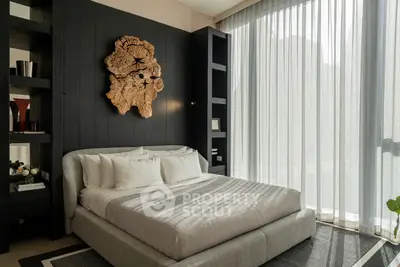 Luxurious bedroom with modern decor and large window for natural light.