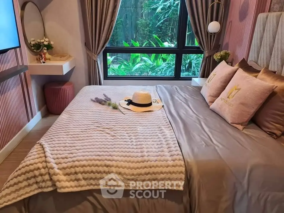 Cozy bedroom with stylish decor and garden view, perfect for relaxation.
