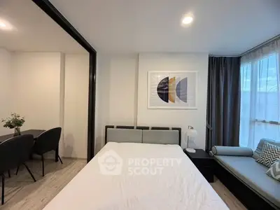 Modern bedroom with stylish decor and cozy seating area