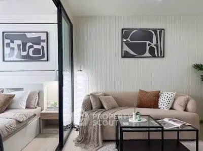 Modern living room with cozy sofa and stylish decor adjacent to a bedroom.