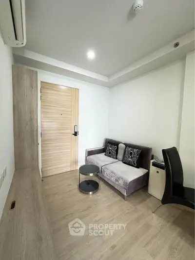 Modern living room with sleek furniture and wooden flooring