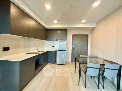 Modern kitchen with sleek cabinets and dining area in stylish apartment