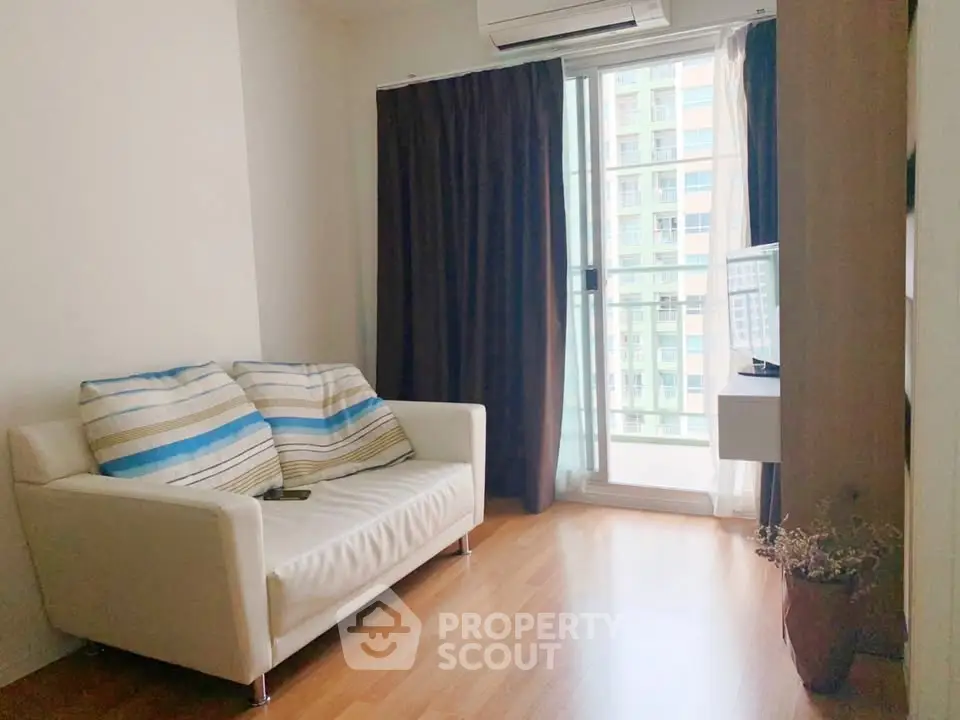 Cozy living room with modern sofa and balcony view in urban apartment