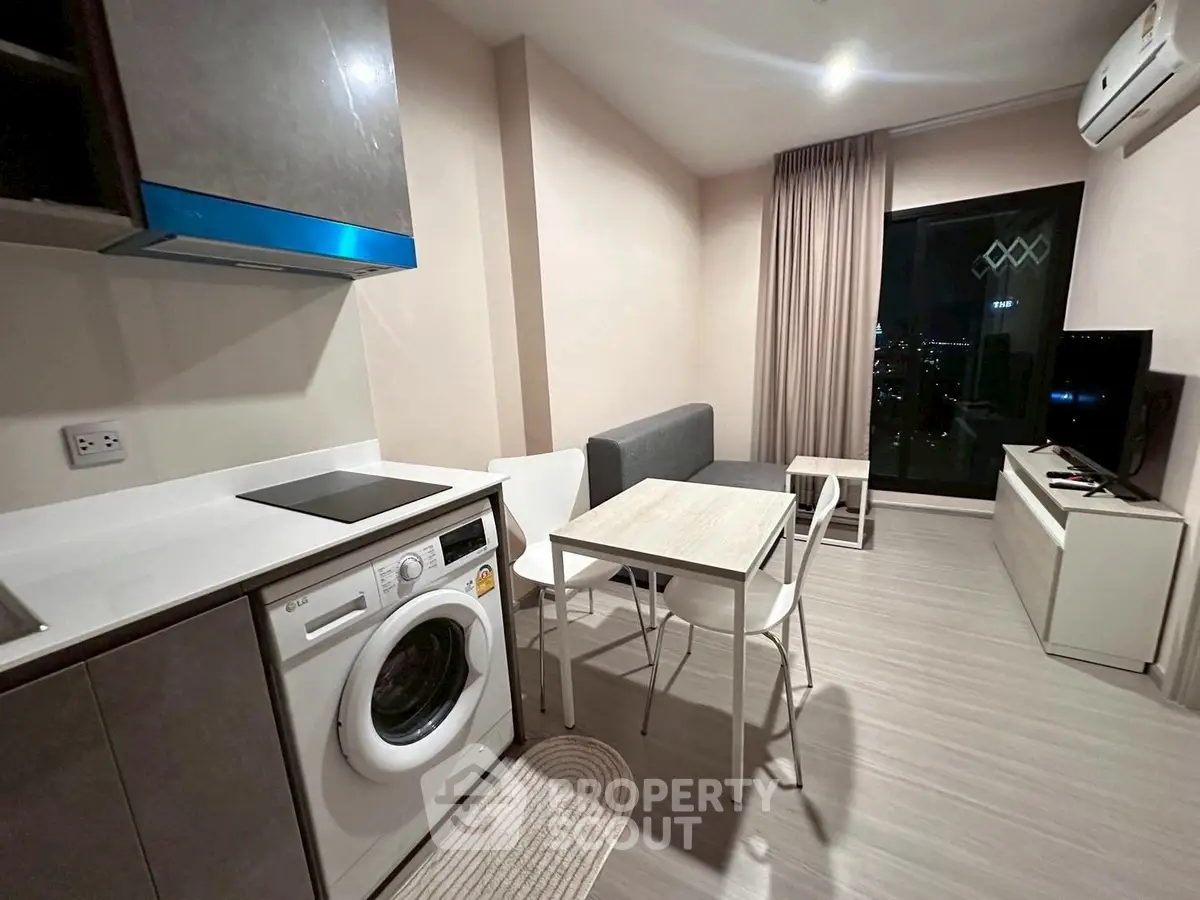 Modern compact living room with kitchen and city view