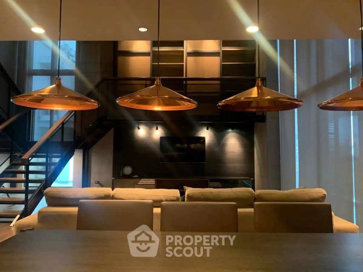 Luxurious modern living room with stylish lighting and open staircase