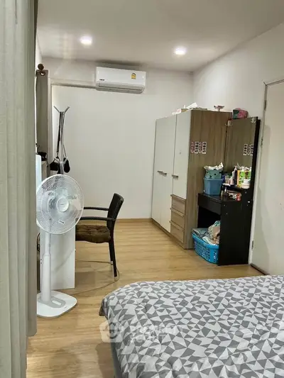 Cozy bedroom with modern decor, featuring a comfortable bed, wardrobe, and air conditioning for ultimate relaxation.
