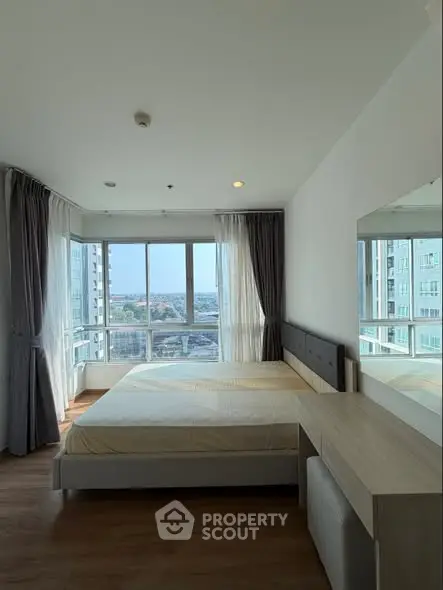 Bright bedroom with large windows and city view in modern apartment