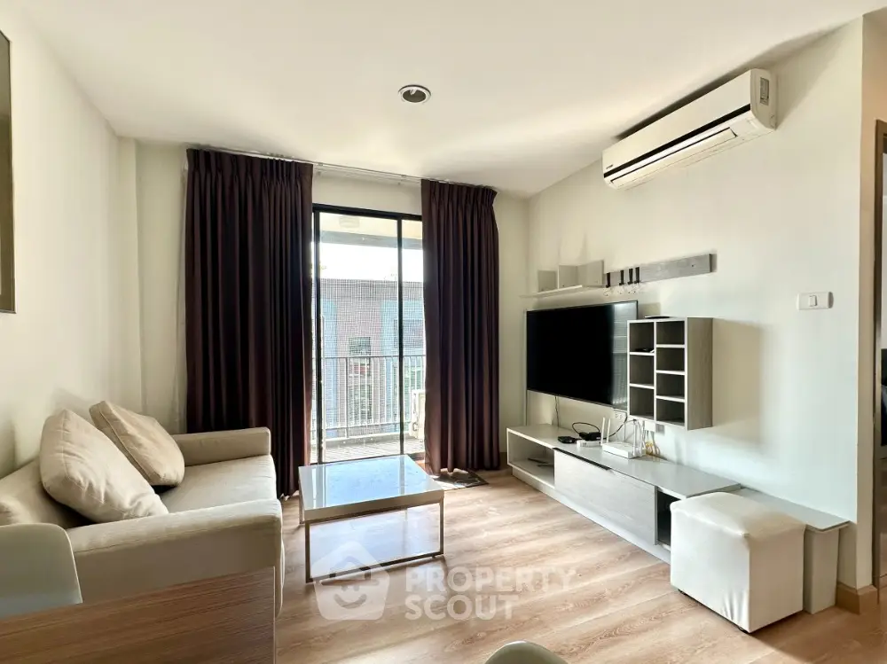 Modern living room with balcony access and stylish furniture
