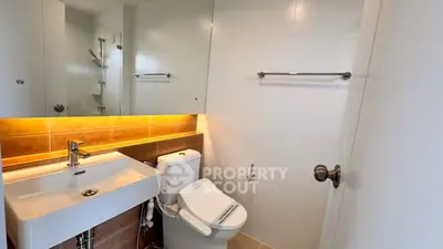 Modern bathroom with sleek fixtures and warm lighting