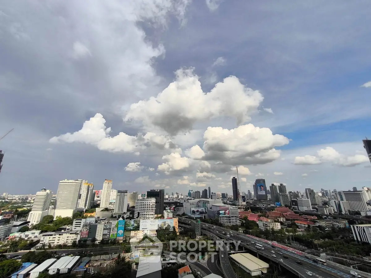 Stunning cityscape view showcasing a vibrant urban skyline under a dramatic cloudy sky.