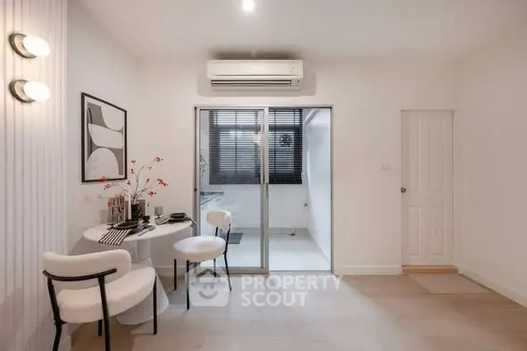 Modern minimalist dining area with sliding glass doors and air conditioning