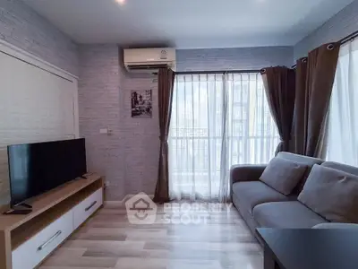 Modern living room with sleek furniture and large windows for natural light.