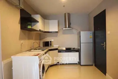 Modern kitchen with sleek appliances and open layout in stylish apartment.