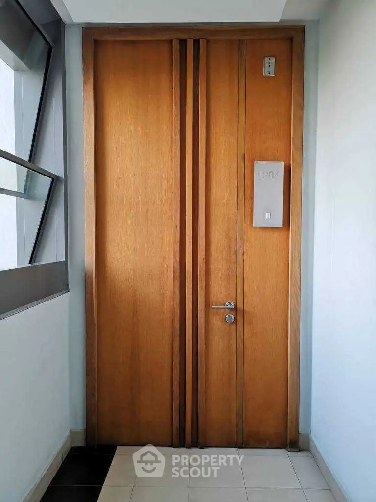 Modern wooden apartment door with sleek design and elegant handle, perfect for contemporary living spaces.