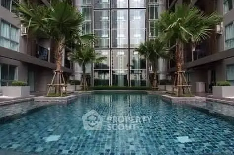 Luxurious condominium with stunning pool and modern architecture.