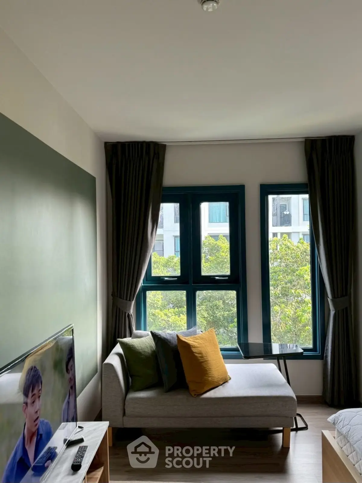 Modern living room with stylish decor and large windows offering a scenic view.