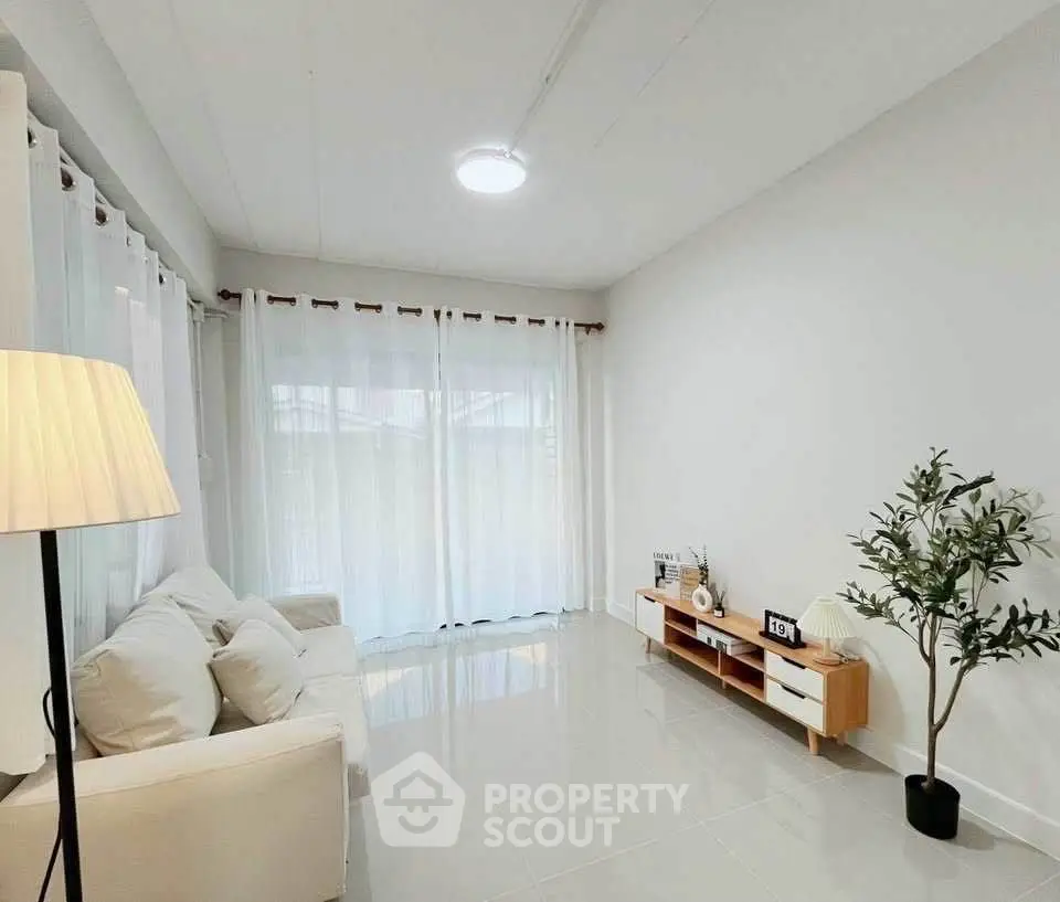 Bright and modern living room with sleek furniture and large windows for natural light.