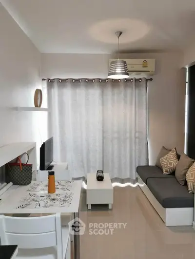 Modern living room with sleek furniture and stylish decor in a cozy apartment setting.