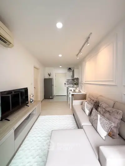 Modern living room with cozy sofa and open kitchen layout