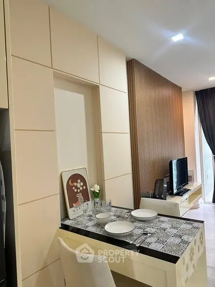 Modern living room with stylish decor and dining area in open layout apartment.