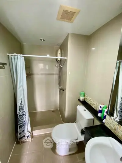 Modern bathroom with shower, toilet, and stylish decor