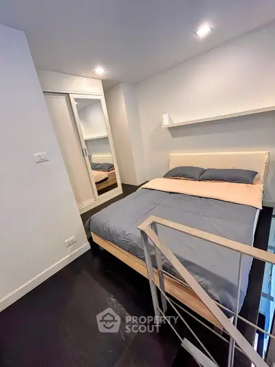 Cozy modern bedroom with stylish decor and mirrored wardrobe