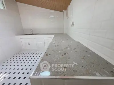 Modern kitchen with sleek countertops and white tile backsplash