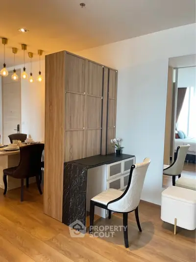 Modern dining area with elegant furniture and stylish lighting in a contemporary apartment.