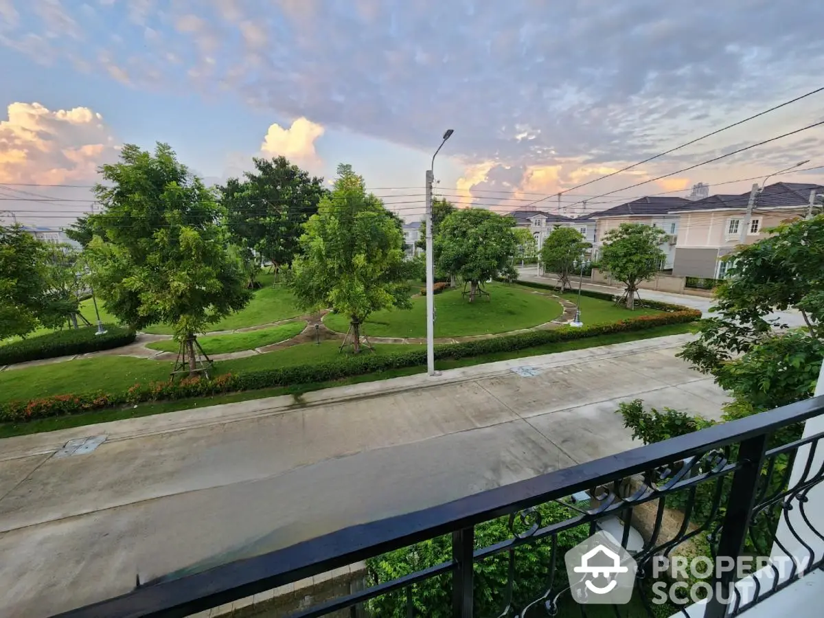 Charming suburban neighborhood view from balcony with lush greenery and serene atmosphere.