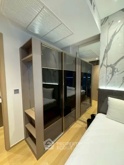 Modern bedroom with sleek wardrobe and stylish marble accents