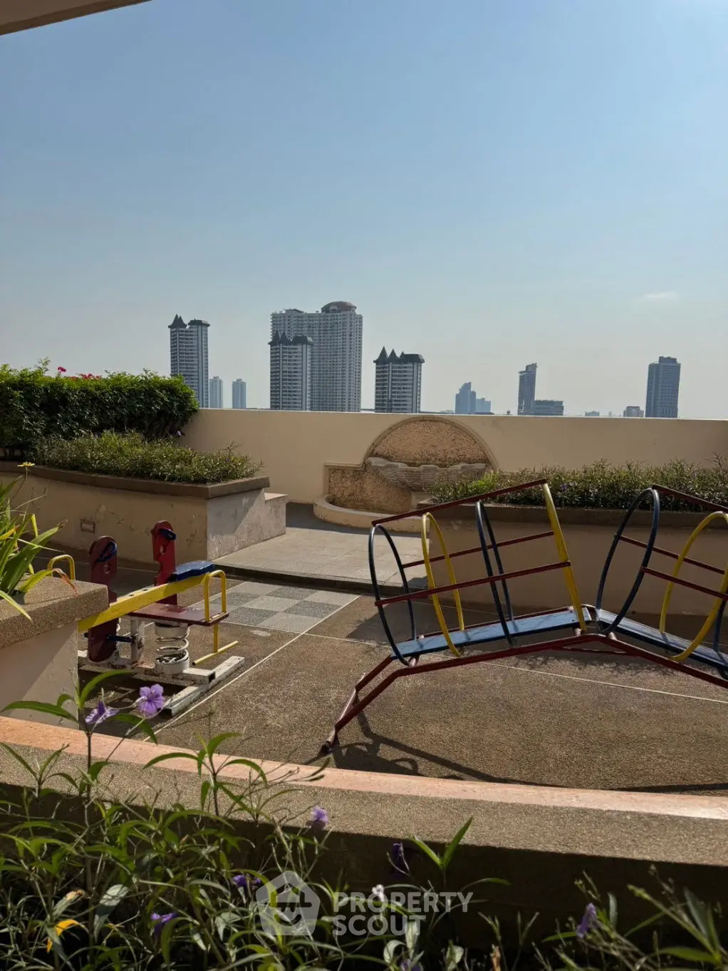Stunning rooftop garden with city skyline view and play area