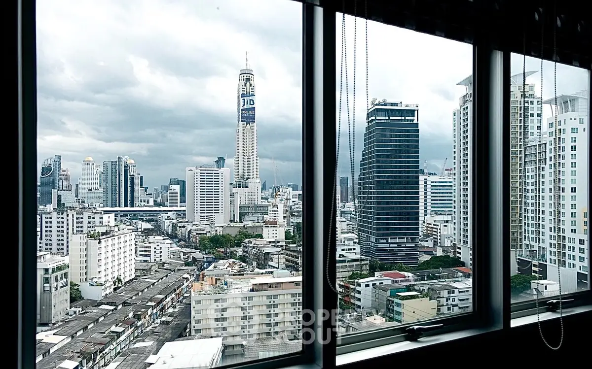 Stunning cityscape view from high-rise apartment window showcasing urban skyline.