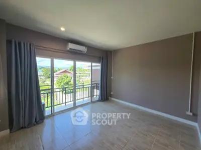 Spacious empty room with large windows and balcony view, perfect for customization.
