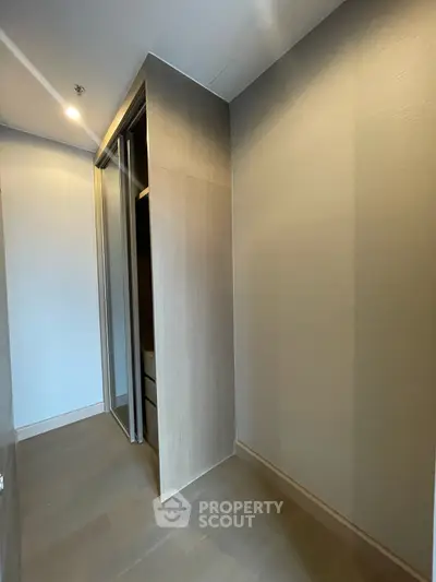 Spacious walk-in closet with modern sliding doors and ample storage space.